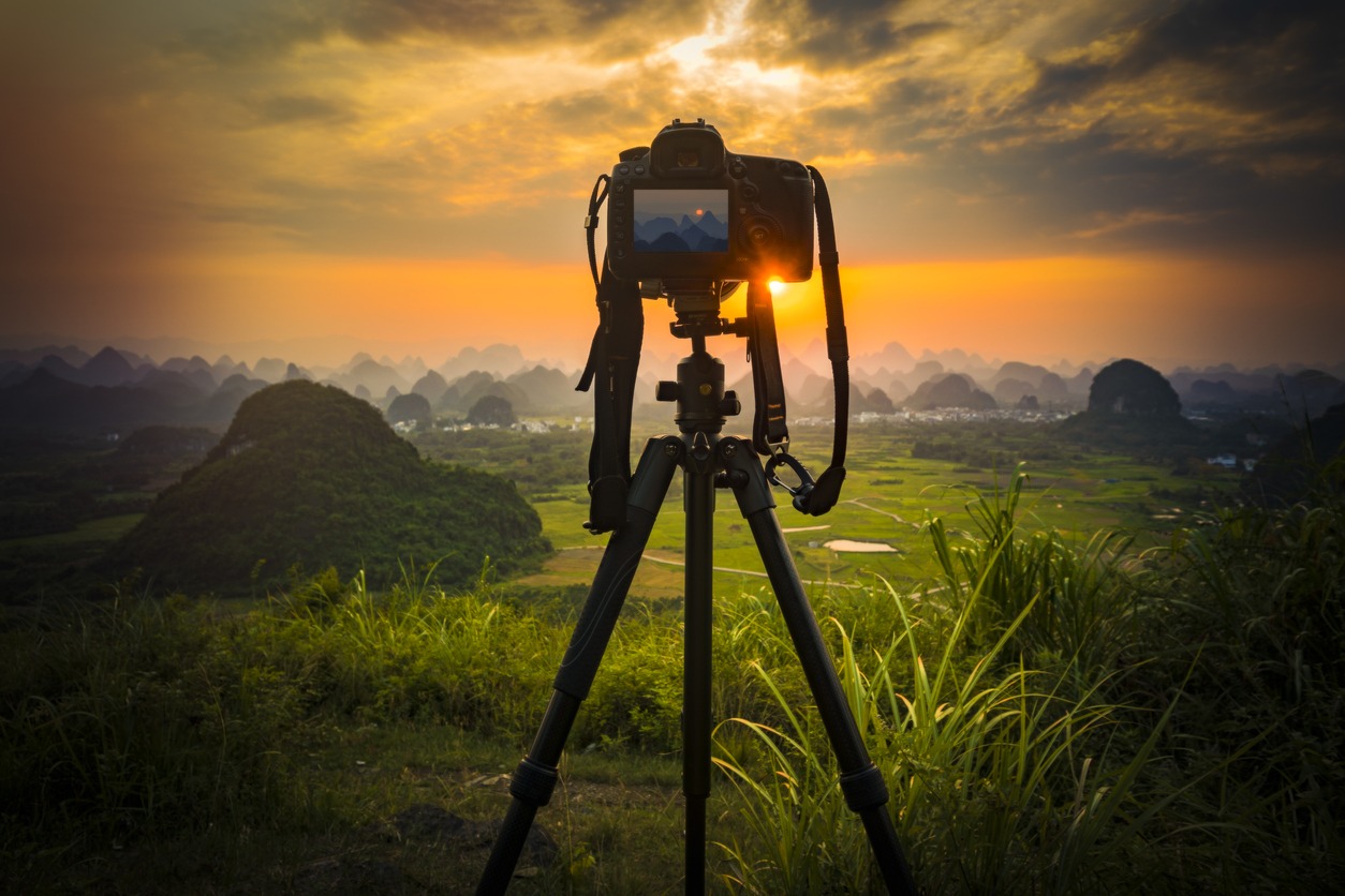 A camera set on a tripod to take landscape pictures