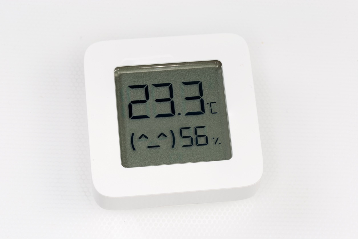 A digital hygrometer measuring temperature and humidity levels.