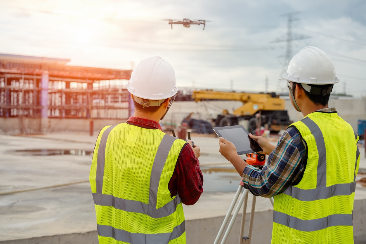 A drone flies over a construction site.