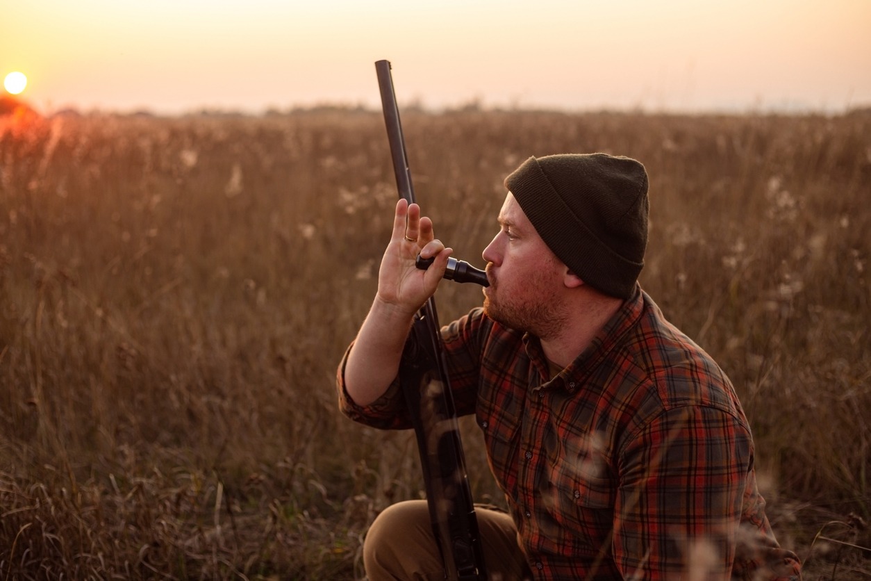 A hunter blowing a whistle