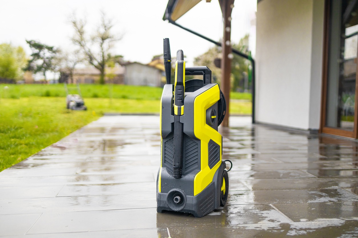 A pressure washer on a recently washed concrete floor