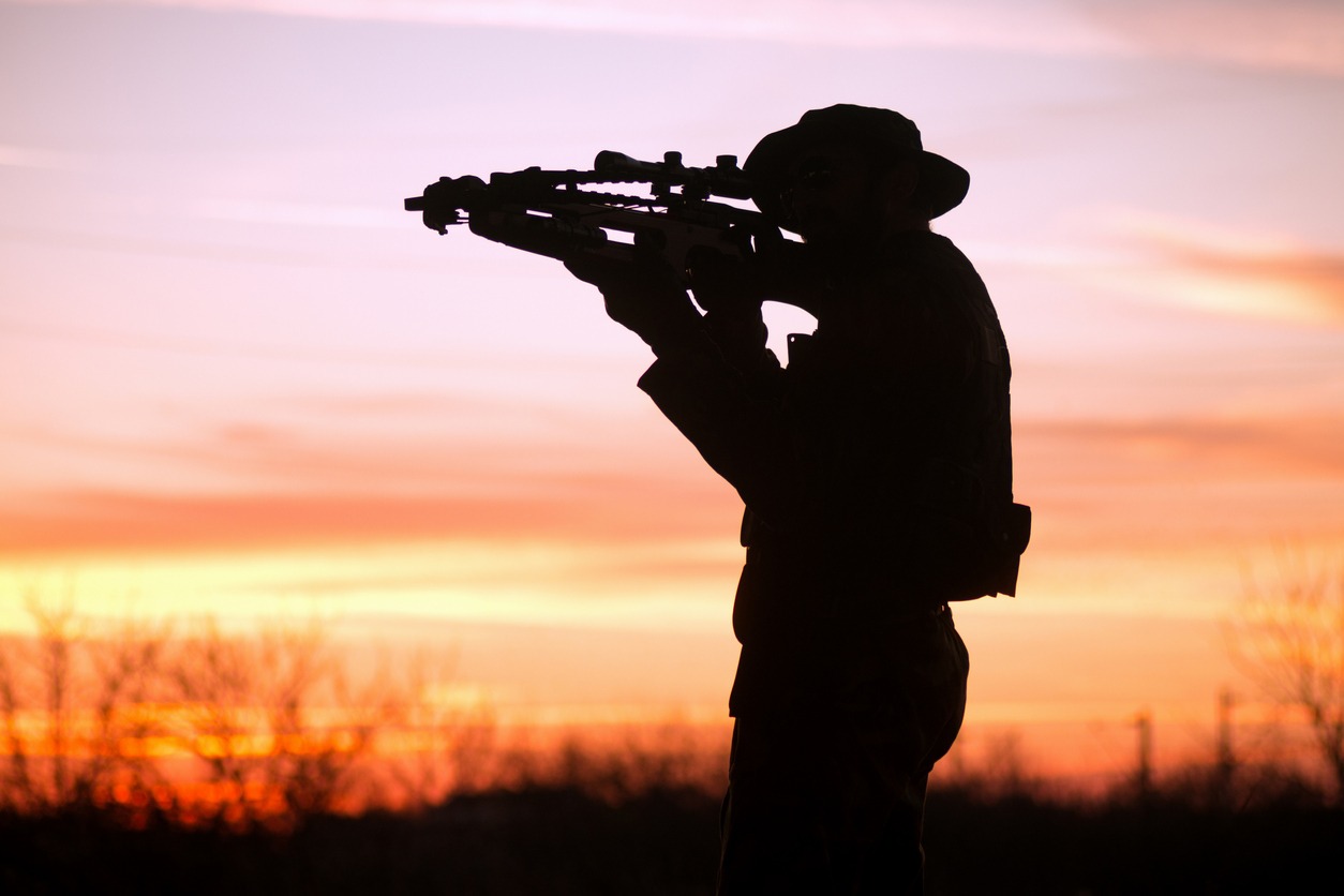 A silhouette of a man with a crossbow