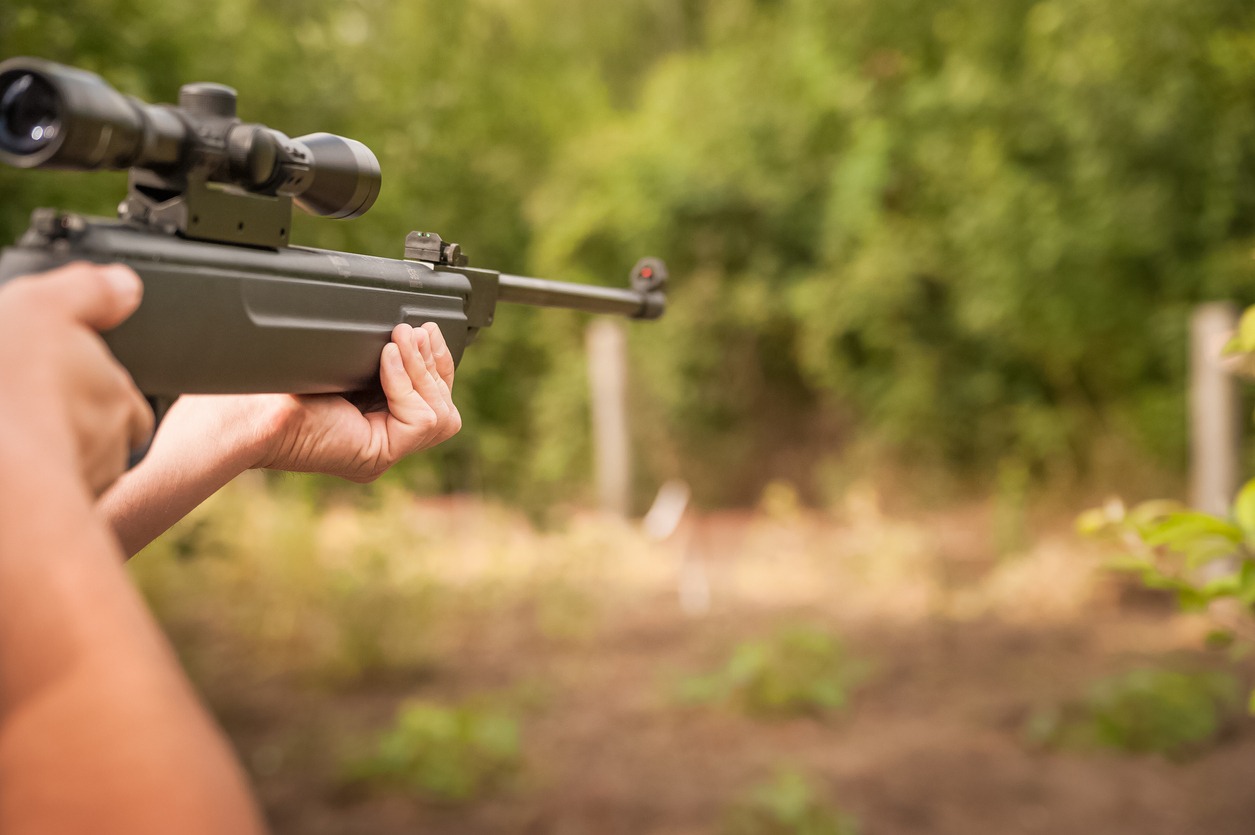 Closeup of man hunting with a gun.