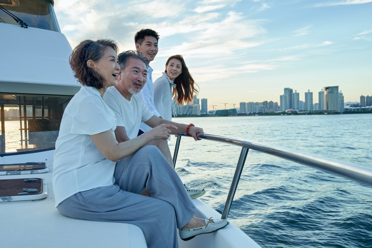 Happy family aboard a yacht out to sea.