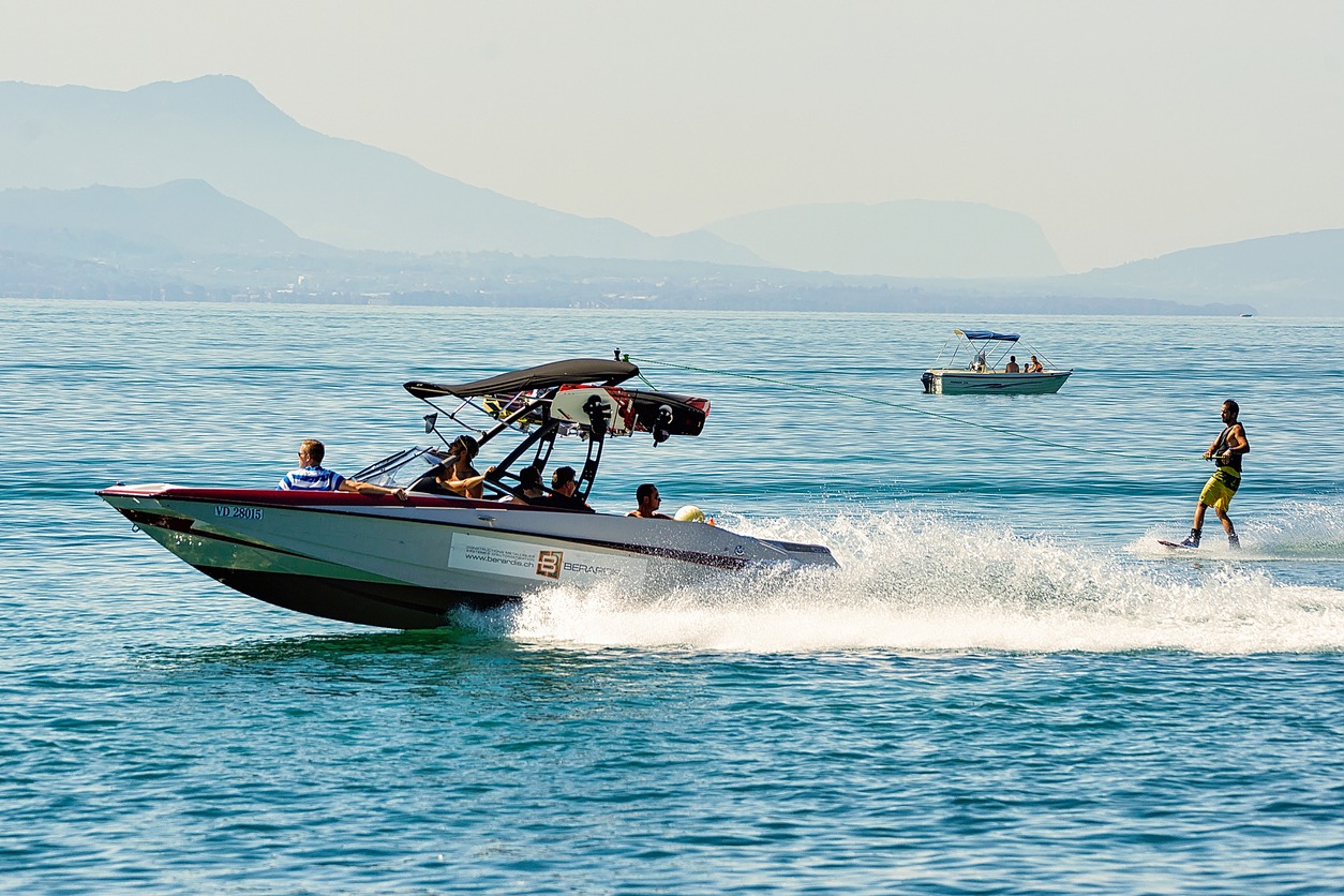 Motorboat with man wakeboarding on Lake Geneva in Lausanne, Switzerland
