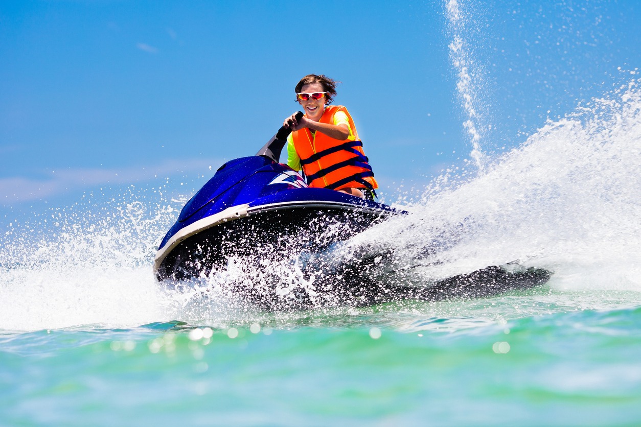 Teenager on jet ski. Teen age boy skiing on water scooter. Young man on personal watercraft in tropical sea. Active summer vacation for school child. Sport and ocean activity on beach holiday