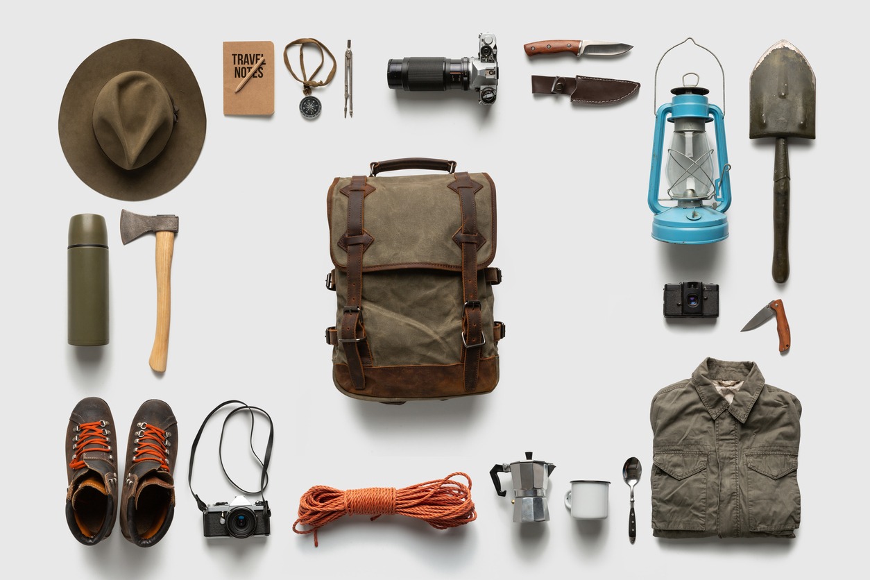 Traveler set on white background isolated. Packing backpack for a trip creative concept