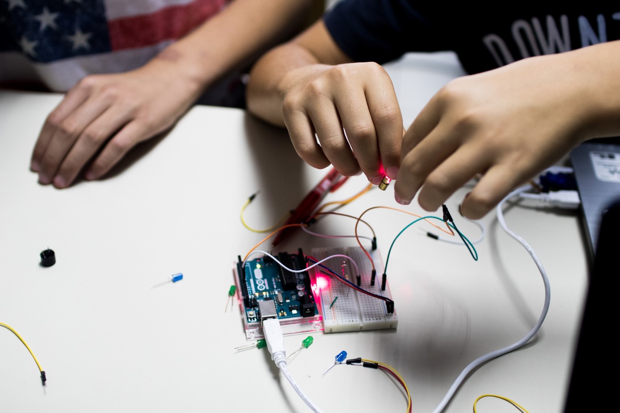 Two children working on a robotic project.