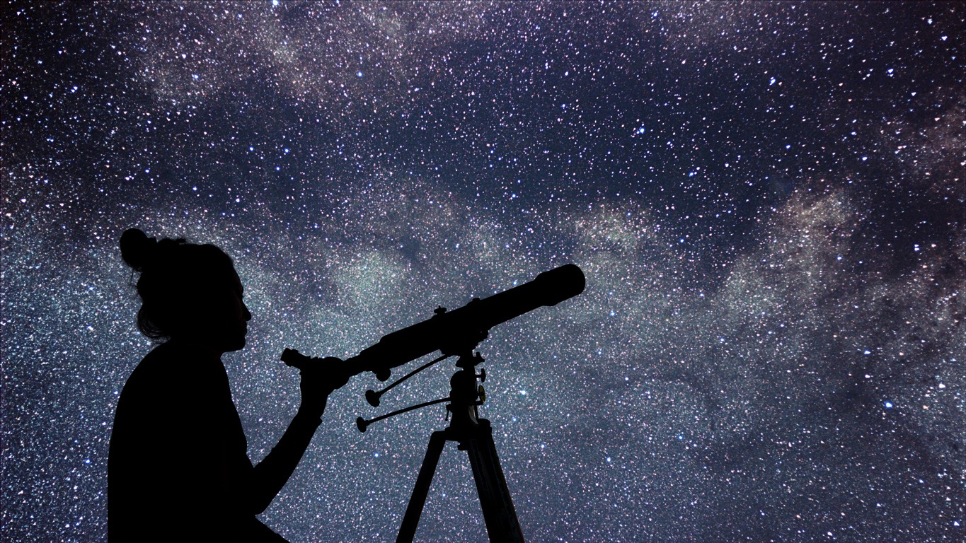 Women with telescope watching stars
