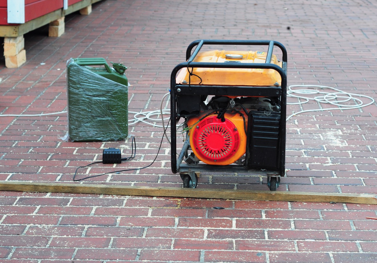 A close-up of a portable diesel generator working during a power blackout, outage. A mobile petrol or diesel generator, as a good power source on a construction site