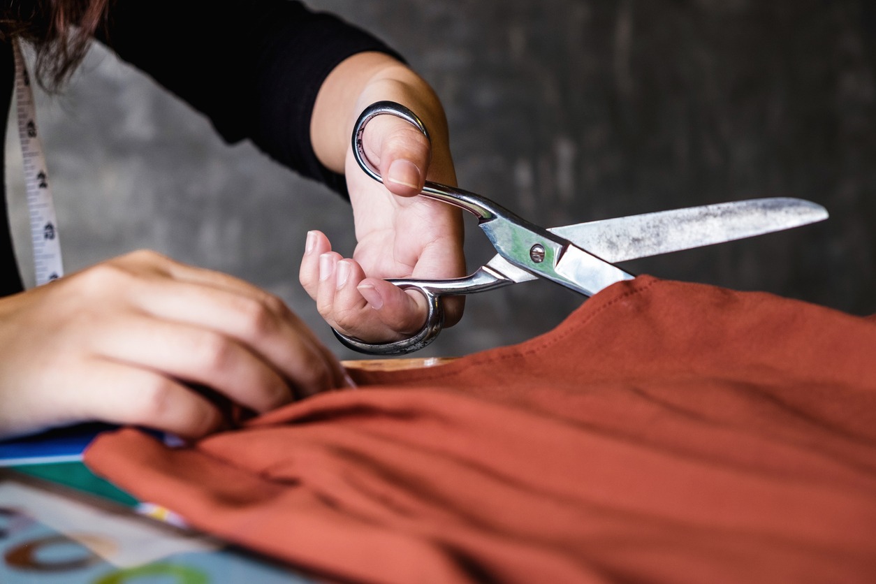 Close up of hands, Young woman dressmaker or designer working as fashion designers measure and Cutting for clothes, profession and job occupation, Fashion Designer Stylish Concept