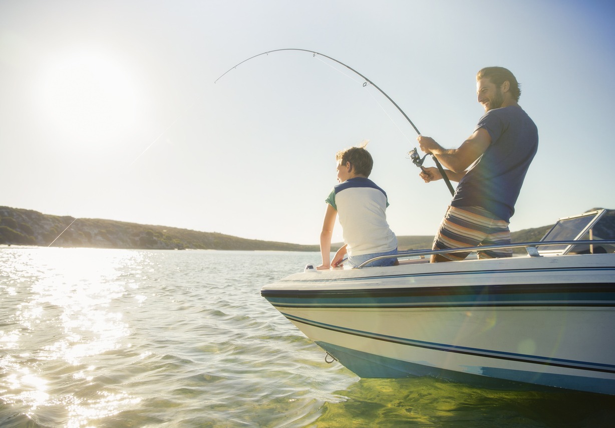 Father and son fishing on boat