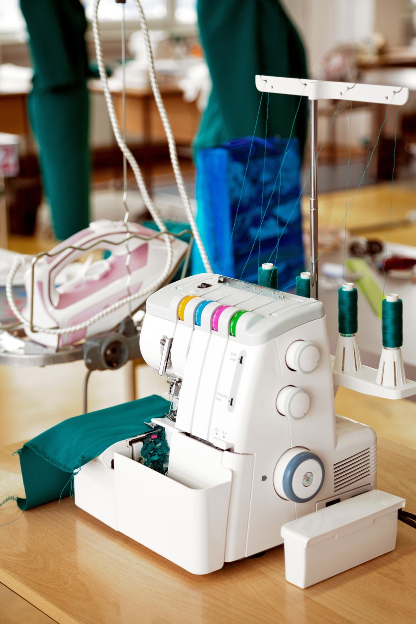 Overlock sewing machine in tailor office. Fashion designer equipment serger