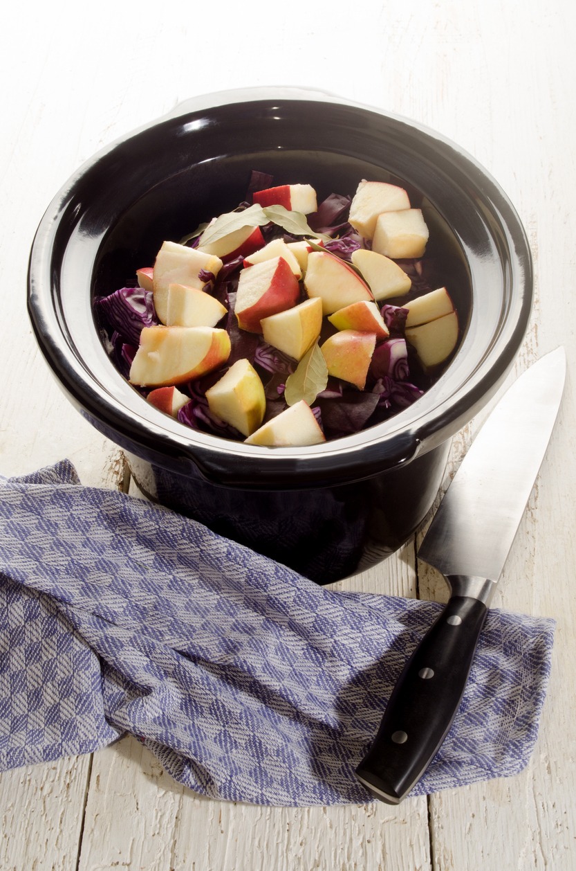 red cabbage with apple and bay leaf in a slow cooker
