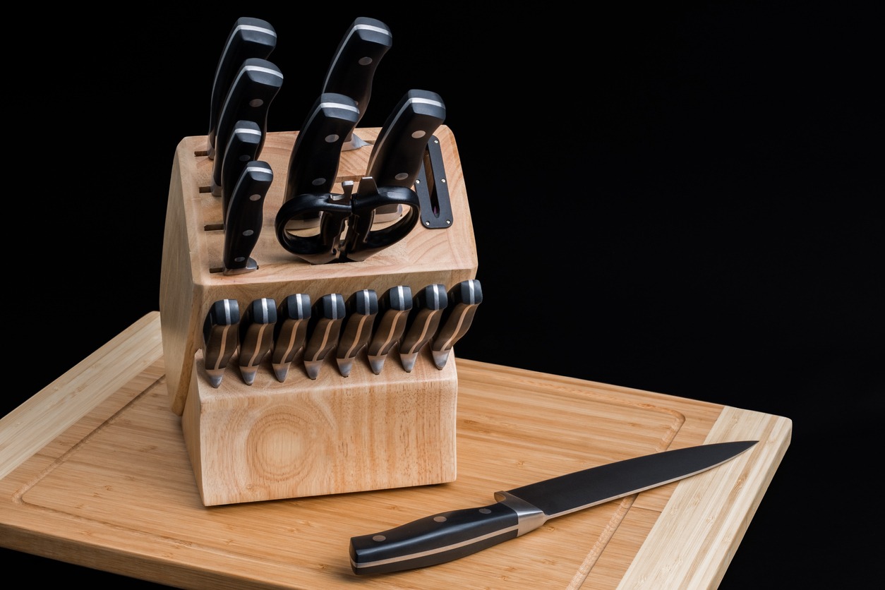Set of kitchen knives on a wooden cutting board