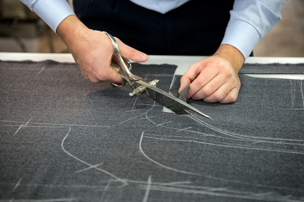 Tailor cutting fabric
