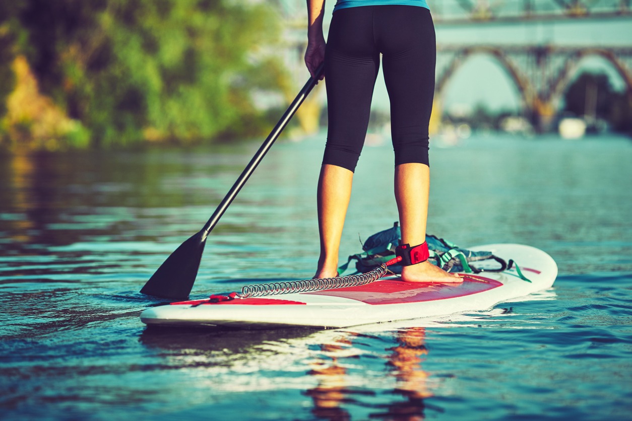 A girl learning to paddle on stand-up paddleboards