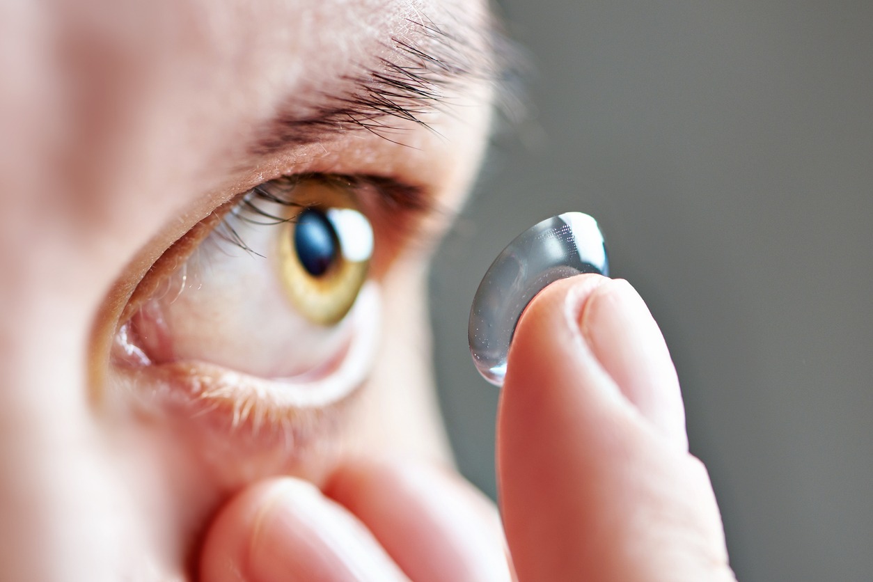 A woman putting on a contact lens