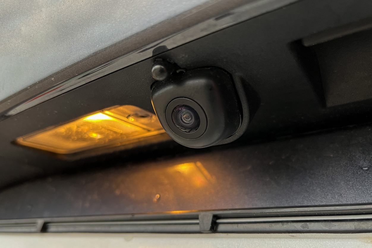 Camera attached near taillights of a car.