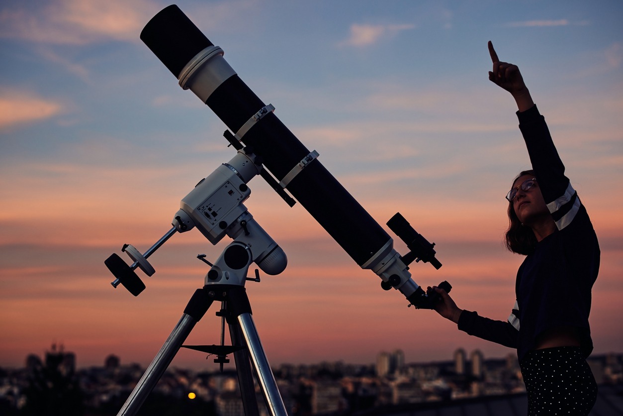 Girl with astronomical telescope