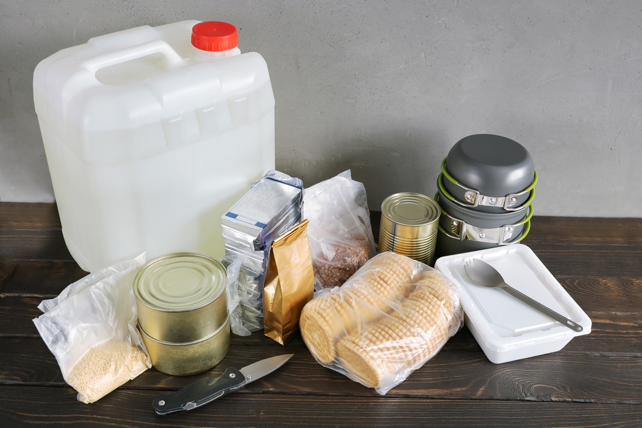 Set of food products for long-term storage, a container with drinking, need for emergency, with copy space