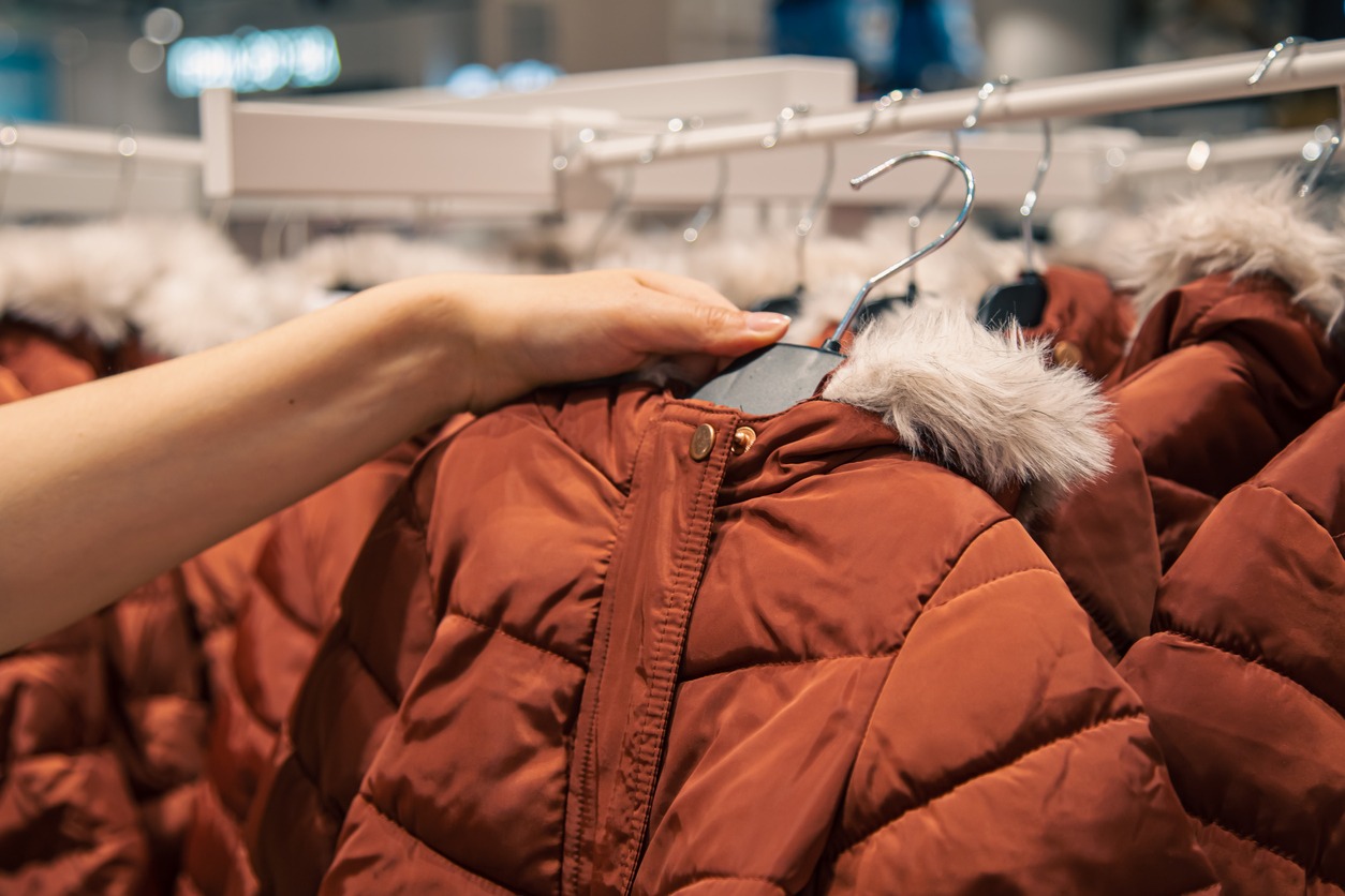 down jackets on hangers in a clothing store