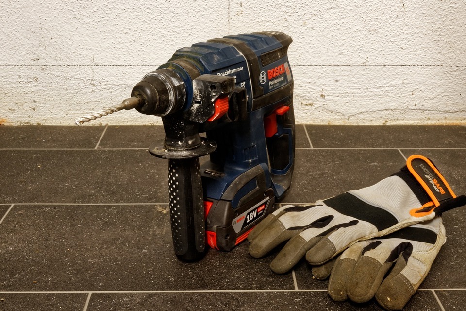 A rotary hammer drill with safety gloves