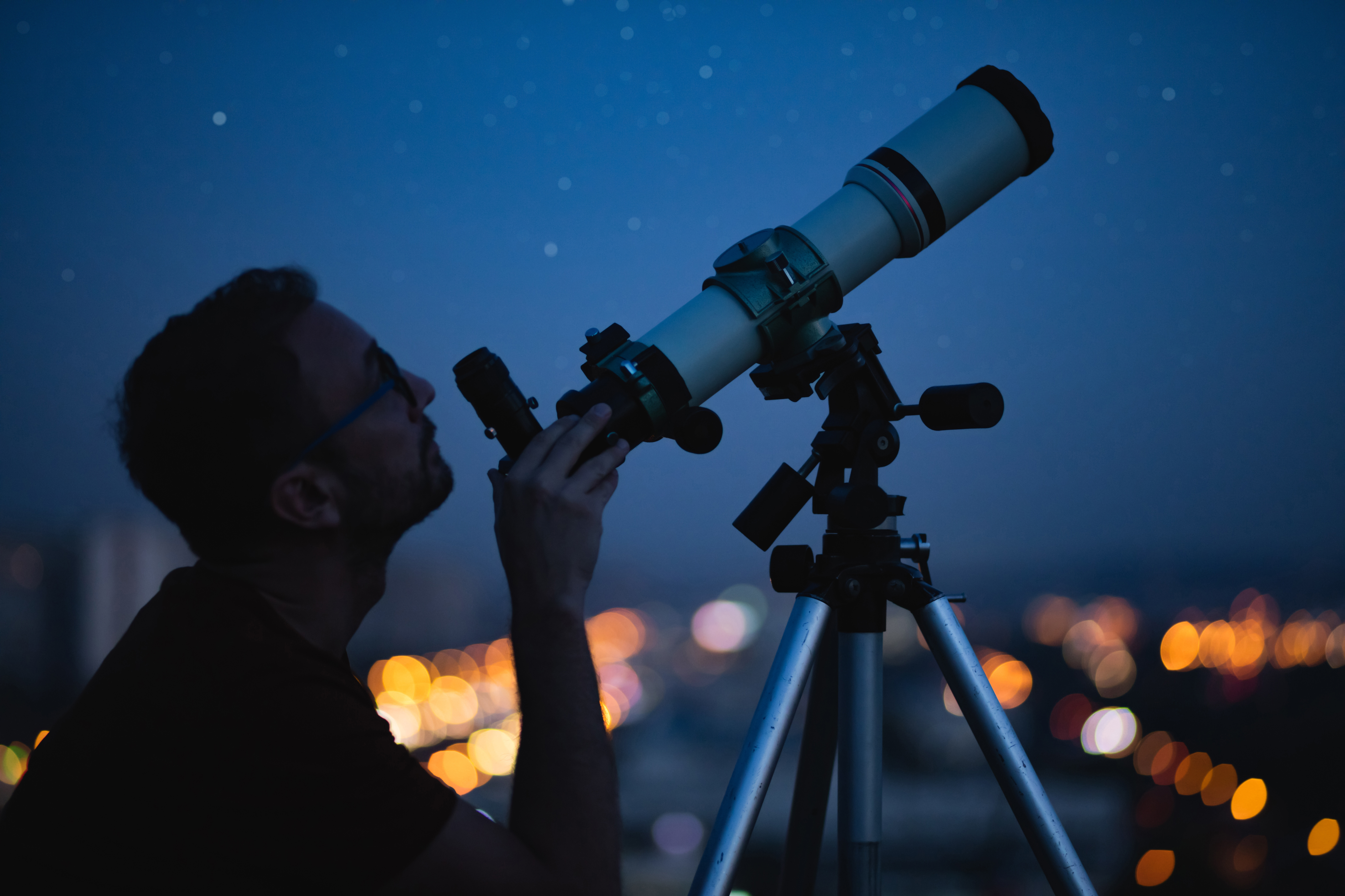 man looking through a telescope
