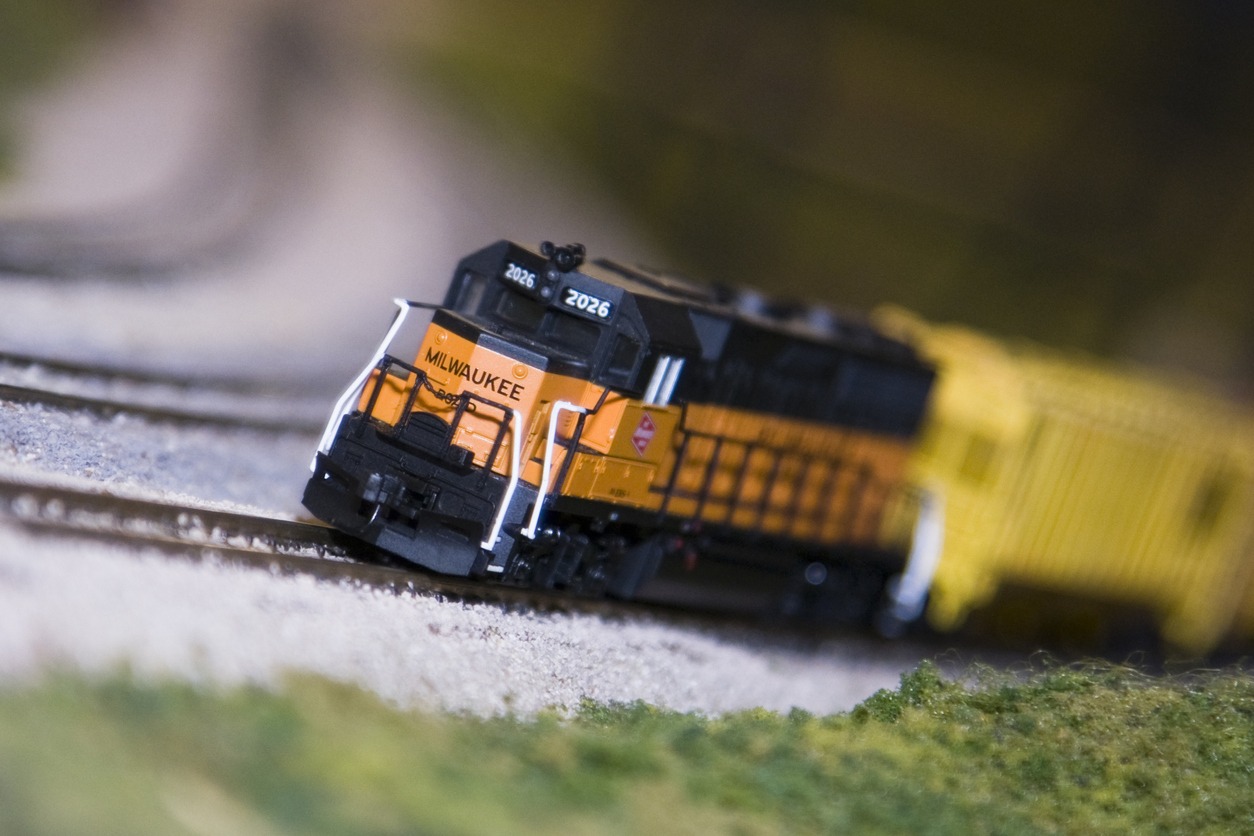 Close-up of a model train running through a grassy land