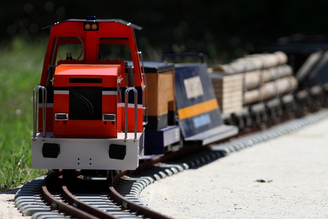 Closeup of a red model train on a set of tracks