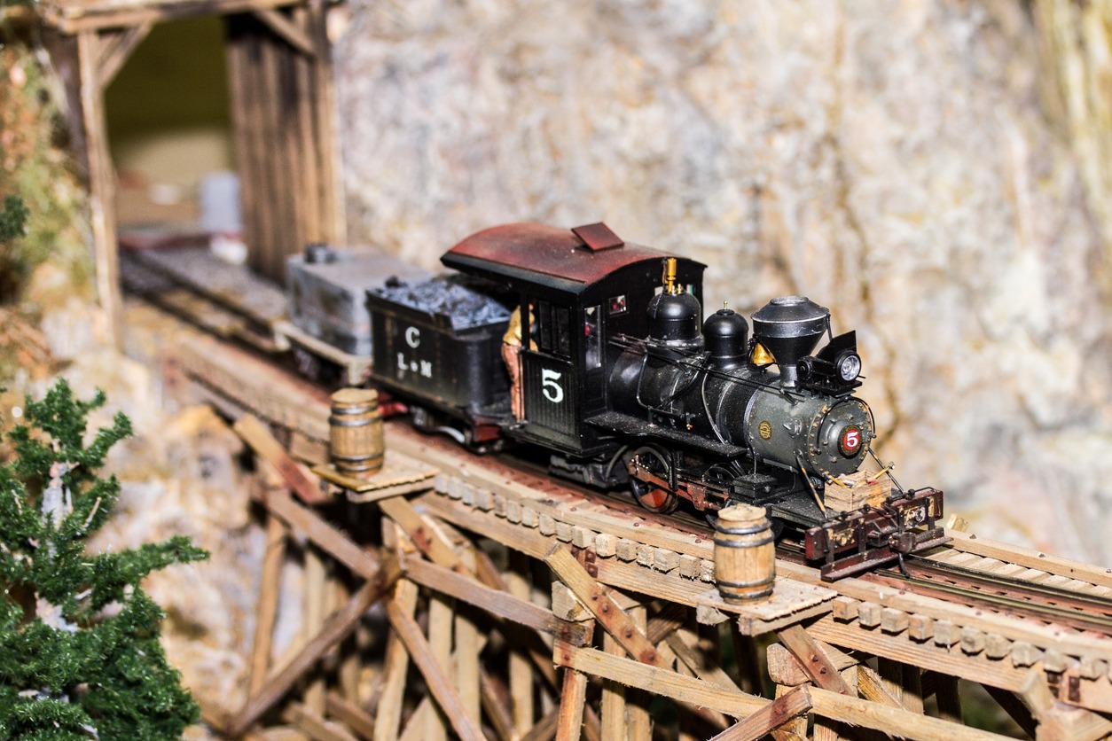 Model  train running through a handmade mountain