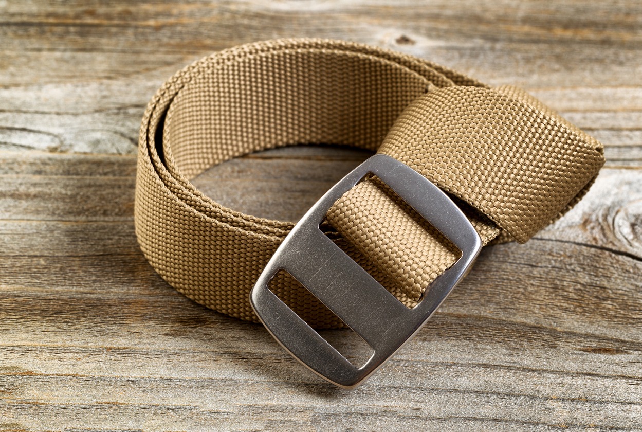 Utility nylon belt with buckle on rustic wooden boards