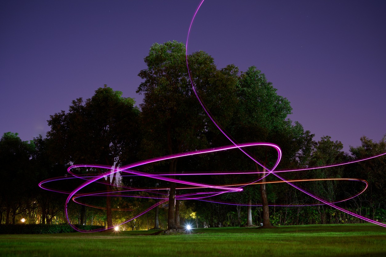 Drones are making a light painting in the air.