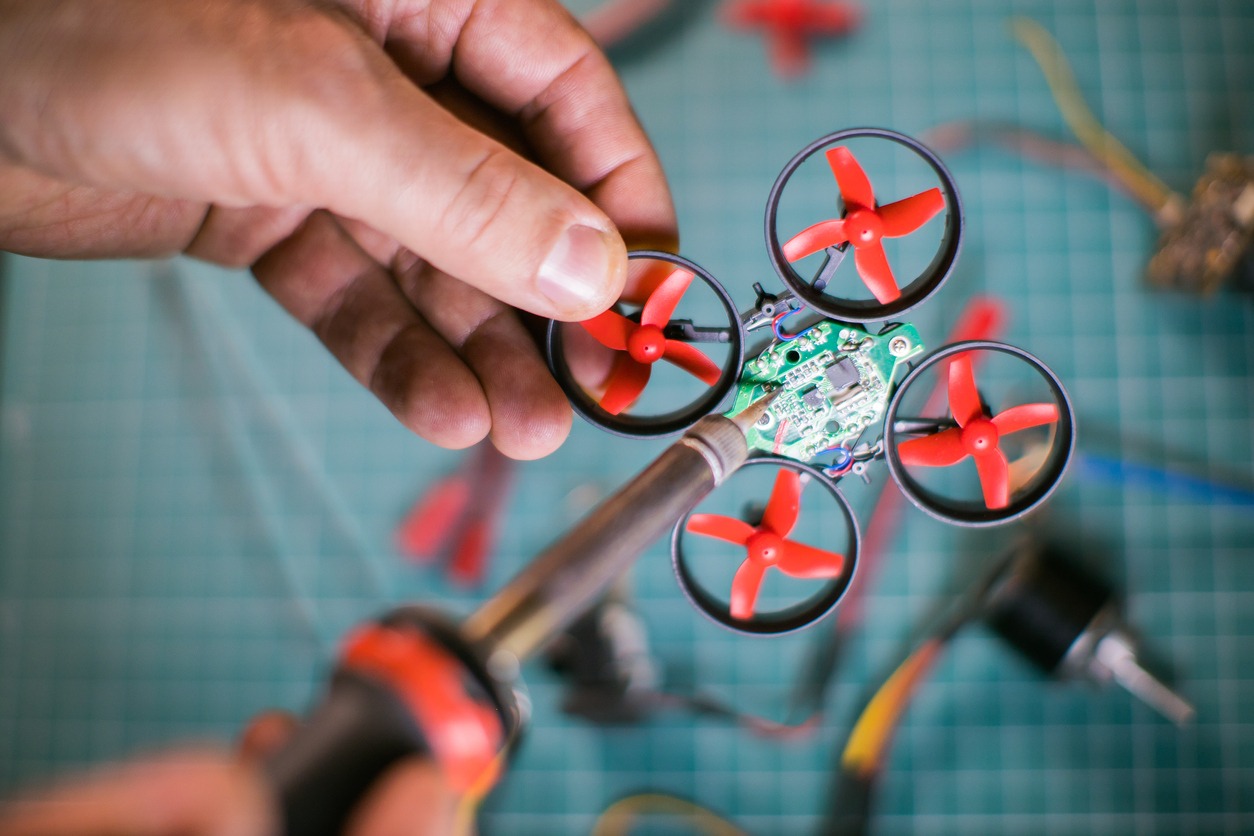 Man working on a tiny drone