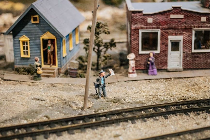 Miniature Model Train track with toy human beings
