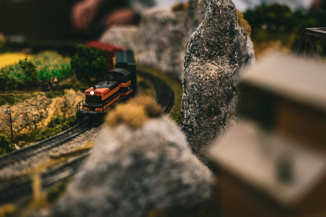 Model Train passing through a rugged landscape