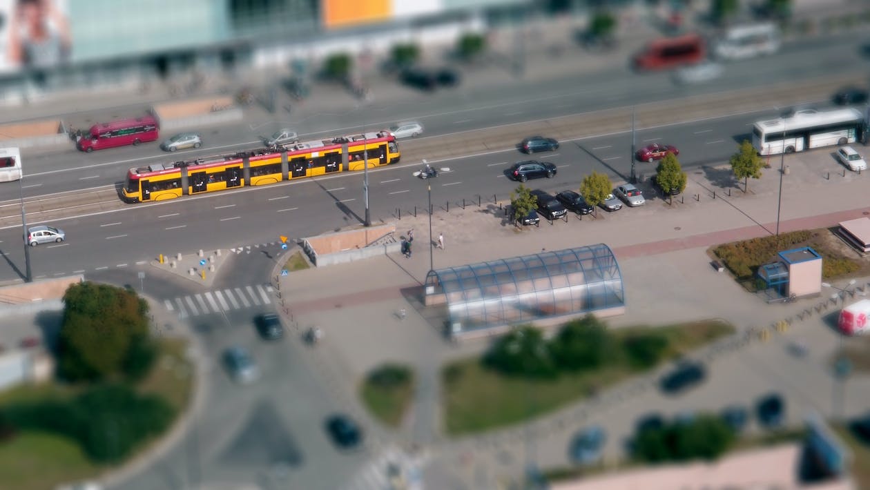 Model Train passing through an urban setting