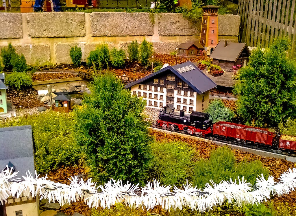 Model train running in a colorful landscape