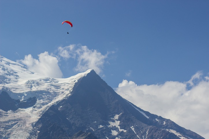 Paragliding over Mont Blanc massif in the French Alps above Chamonix, France