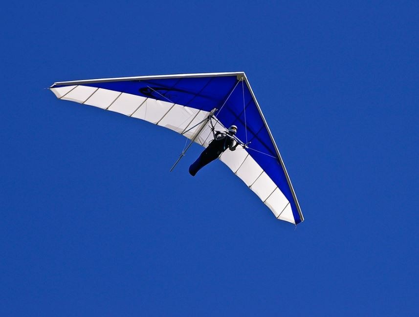 Person hang-gliding, blue sky