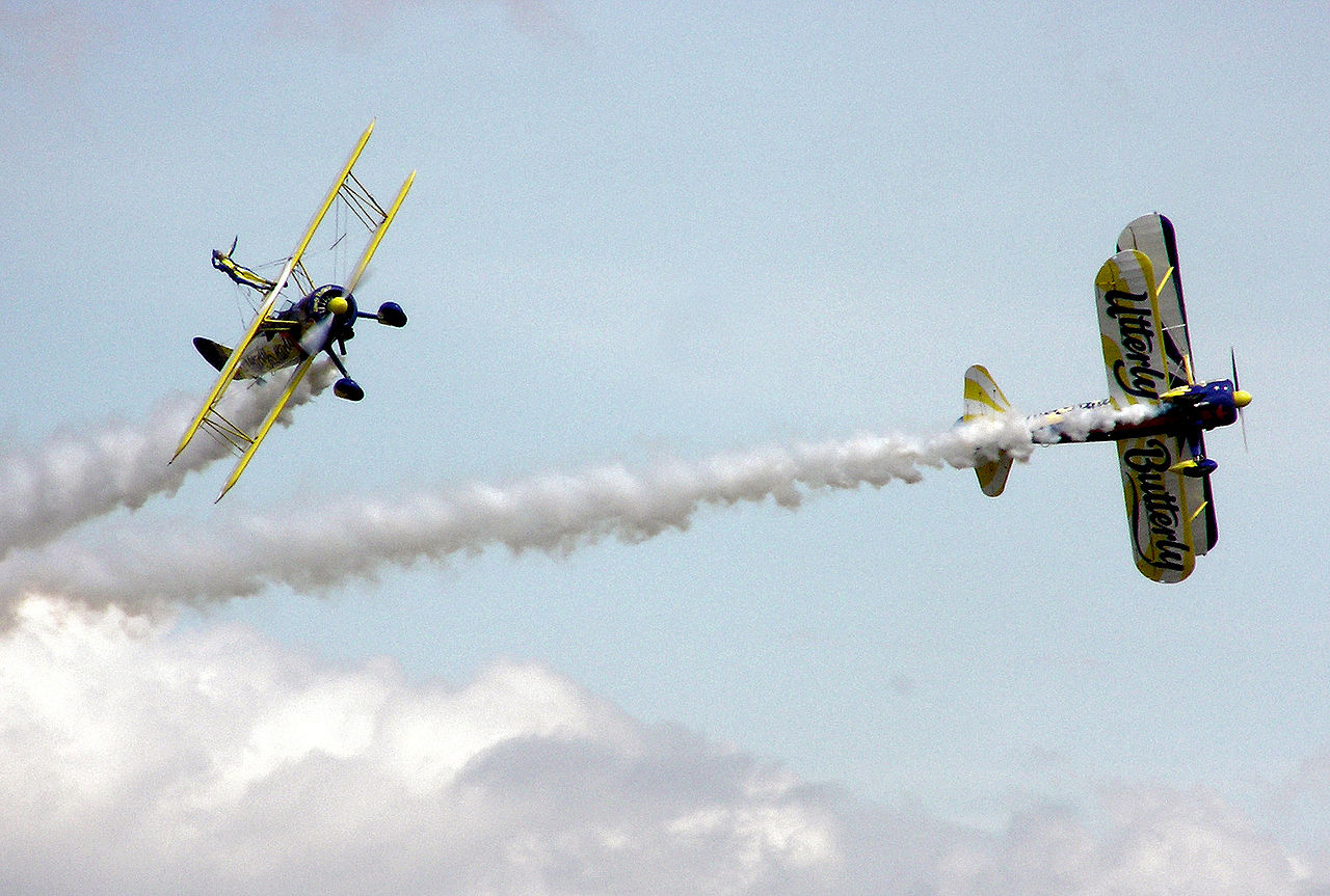 Two planes performing an aerobatic maneuver