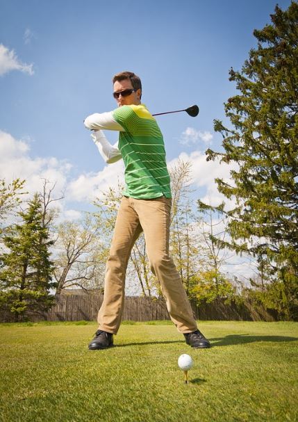 a-man-with-sunglasses-a-man-wearing-long-sleeves-brown-pants-a-man-holding-a-golf-club