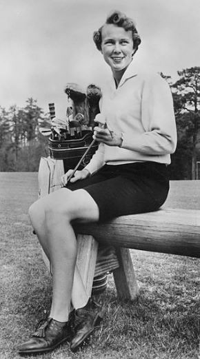 black-and-white-photo-a-woman-sitting-on-a-chair-a-woman-wearing-white-collared-jacket-with-black-fitted-shorts-a-woman-holding-a-golf-club