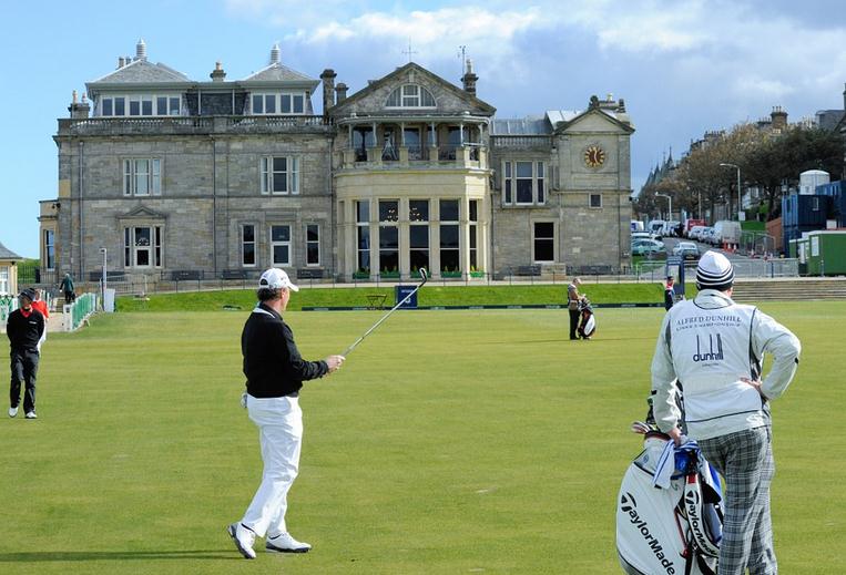 men-playing-golf-in-a-course-surrounded-by-modern-structures-in-Scotland