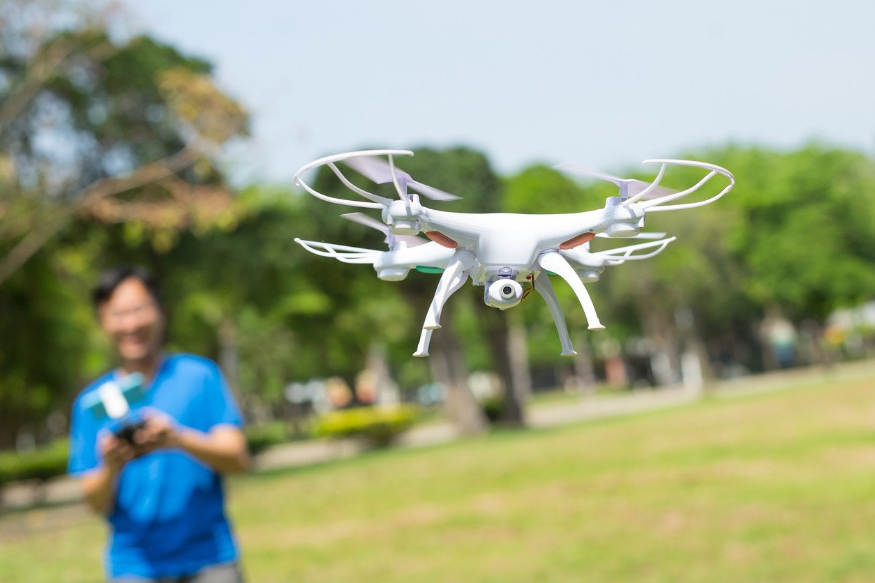 Man-play-drone-in-the-park-happily