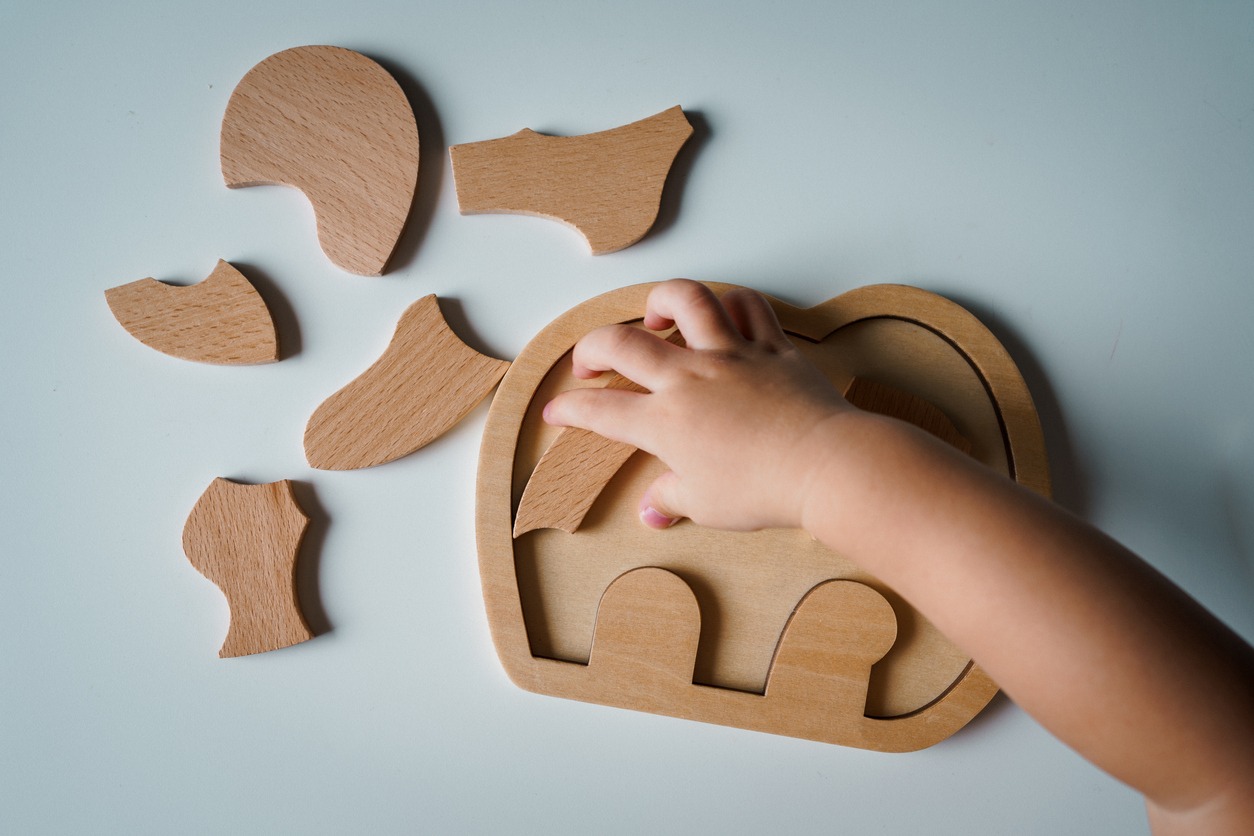 a child playing wooden puzzle