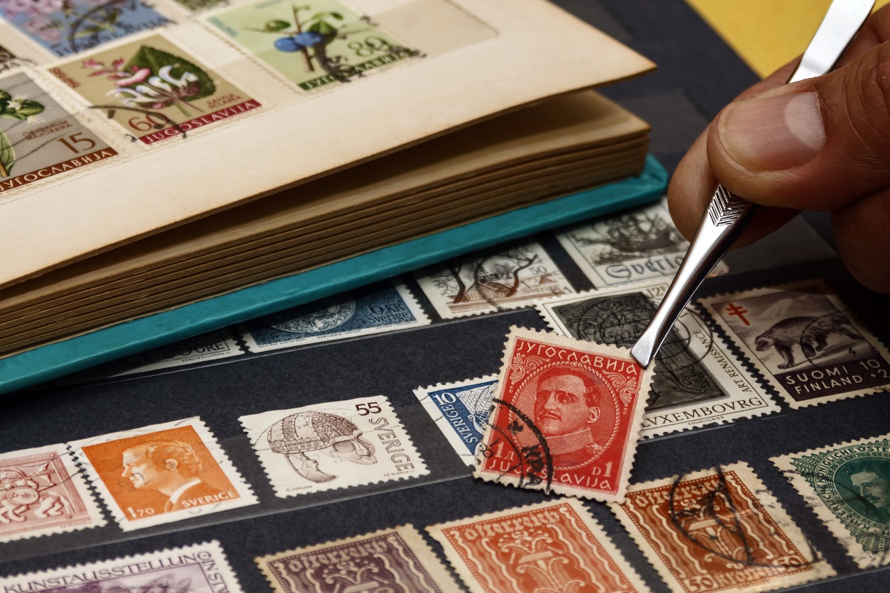 philatelist looks at postage stamps