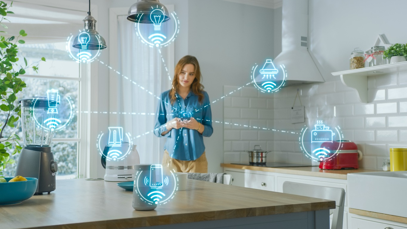a young woman in her kitchen controlling appliances with IoT