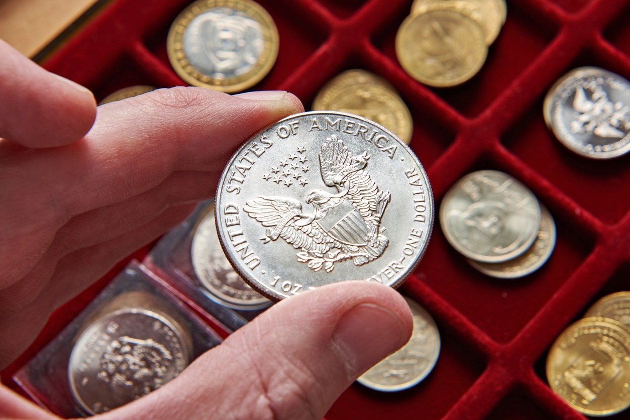 an American dollar in the hand of a coin collector