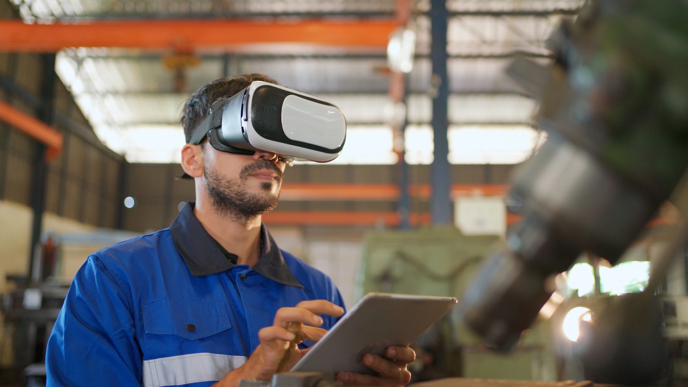 an engineer wearing virtual reality headset in the manufacturing factory